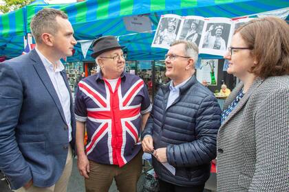 El líder del Partido Unionista Democrático de Irlanda del Norte, Jeffrey Donaldson, habla con los ciudadanos durante su visita al mercado de la Feria de Mayo en Holywood Co Down, el 2 de mayo de 2022, como parte de su campaña política para las próximas elecciones locales.