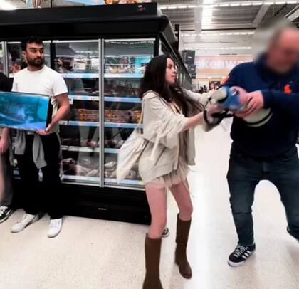 El momento donde el hombre le saca violentamente el megáfono a la activista para luego destruirlo contra el piso