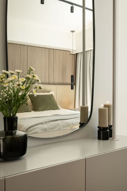 El mueble flotante para la TV aporta liviandad. Hecho a medida en madera maciza y hierro laqueado en gris, incluye iluminación en estantes y base.