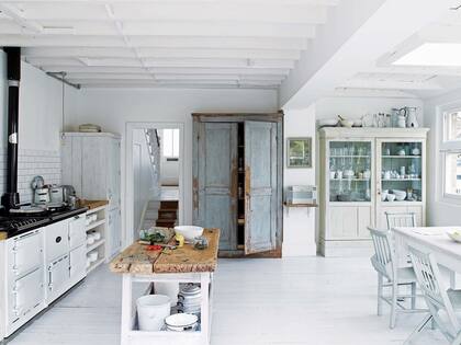 En la cocina, el mueble tipo despensa, junto a la envidiable colección de cacerolas blancas, esconde la heladera.