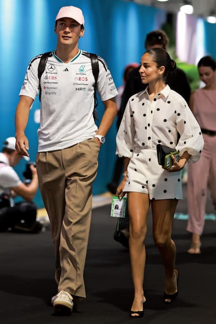 El piloto británico George Russell y su novia desde hace seis años, Carmen Montero Mundt, que también se sumó a la tendencia lunares con camisa y short de Alexis, y cartera Dior