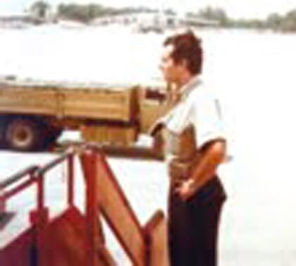 El piloto Carlos Bernard en Trípoli; al fondo, carga de municiones