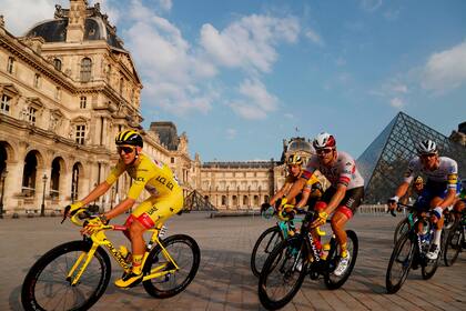 Frente a la pirámide del Louvre el pelotón acompaña al campeón Pogacar