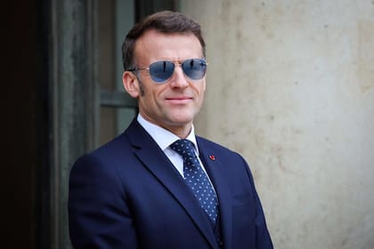 El presidente de Francia, Emmanuel Macron, con gafas de sol, sonríe mientras espera para recibir a los primeros ministros de Groenlandia y Dinamarca en el Palacio del Elíseo, en París,
