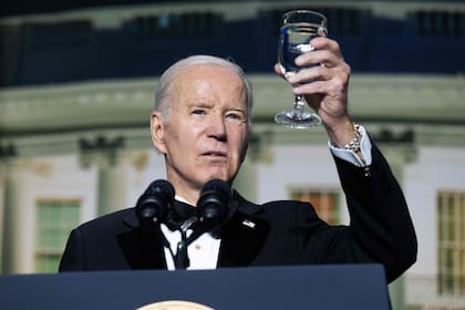 El presidente de los Estados Unidos, Joe Biden, levanta su copa mientras habla durante la cena de la Asociación de Corresponsales de la Casa Blanca en el Washington Hilton en Washington, DC, el 29 de abril de 2023