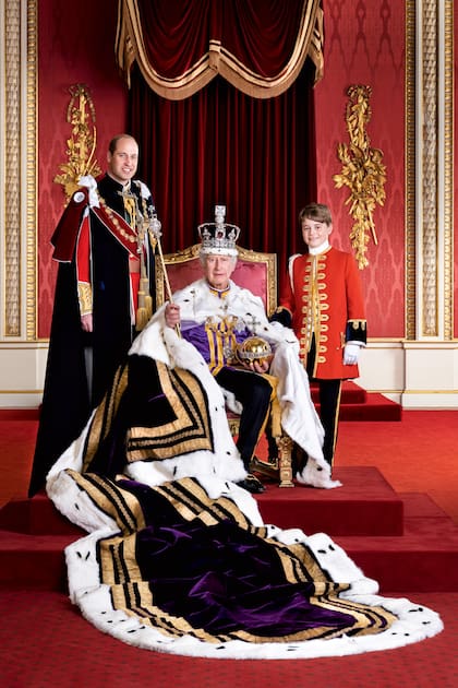 El príncipe de Gales y su primogénito, el príncipe George, junto al rey Carlos III el día de su coronación, en el Salón del Trono del Palacio de
Buckingham, Londres. 
