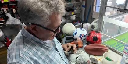 El proceso para reparar un balón inicia cuando Riveros lo infla para detectar el pinchazo y luego revisa toda la costura hasta dar con el remate