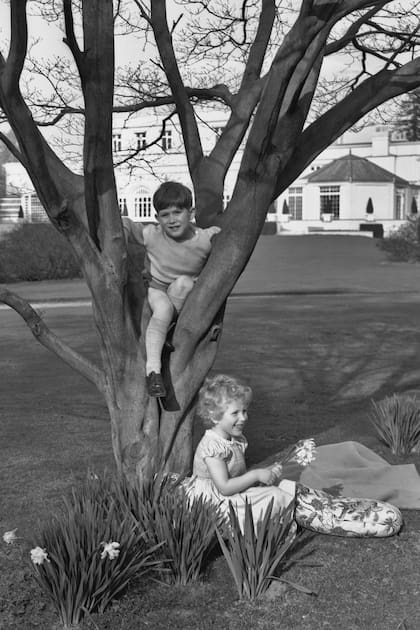 El Rey en su infancia, jugando en los jardines de Royal Lodge con su hermana, la princesa real Ana, en abril de 1954.