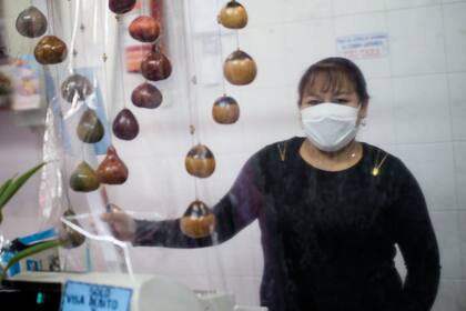 Elizabeth (40). Comercio: Carnicería.¿Cómo es el trato con los clientes? “Hay poca gente, se mantiene la distancia y usamos alcohol en gel, recubrimos todo con film y nos protegemos atrás de esta muralla”.