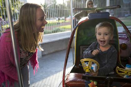 Emilano disfruta de la calesita junto a su mamá