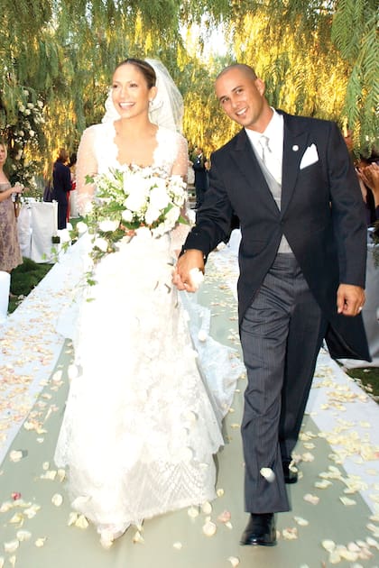Em 2001, Jennifer Lopez se casou com o dançarino Chris Judd e usou um design romântico com decote profundo, saia larga e mangas de tule bordado transparente.