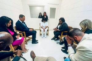 En el centro, Melissa Lucio, una mujer condenada a muerte, reza durante una reunión con legisladores de Texas