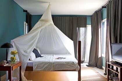 En el dormitorio, el tono ‘Verde 84’ y las cortinas de gasa y lienzo forrado crean la atmósfera ideal a la hora de la meditación.