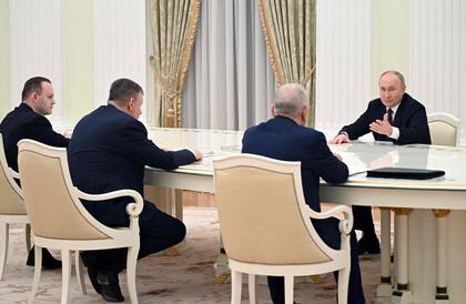 En esta fotografía distribuida por la agencia estatal rusa Sputnik, el presidente ruso Vladimir Putin se reúne con otros candidatos en Moscú el 18 de marzo de 2024, un día después de las elecciones presidenciales.
