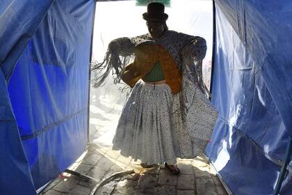 En esta imagen de archivo tomada el 15 de abril de 2020, una mujer aymara boliviana se encuentra dentro del primer túnel de desinfección natural de plantas medicinales, durante la pandemia de coronavirus