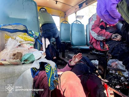En esta imagen proporcionada por los Servicios Ucranianos de Emergencia el martes 7 de abril de 2026, trabajadores de rescate evacúan a personas heridas de un autobús atacado por un dron ruso en Nikopol, en la región de Dnipropetrovsk, Ucrania.