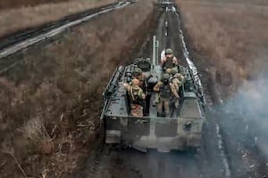 En esta imagen tomada de un video distribuido por el servicio de prensa del Ministerio de Defensa de Rusia el 13 de abril de 2024, soldados rusos avanzan en un vehículo blindado para tomar posiciones y disparar contra posiciones ucranianas, en un lugar no identificado de Ucrania. (Servicio de prensa del Ministerio de Defensa de Rusia vía AP)