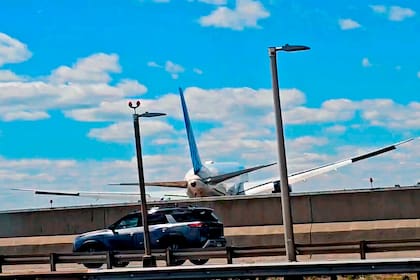 En esta imagen tomada de un video se puede ver a un avión de United Airlines después de chocar con un camión y un poste de luz en una autopista durante su aterrizaje en el Aeropuerto Internacional Newark Liberty