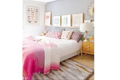 En este dormitorio se eligió un gris claro de fondo y se utilizó el acolchado y los almohadones para incorporar pequeñas dosis de color