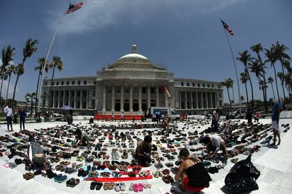 En honor a los fallecidos a raíz del paso del huracán María por Puerto Rico, un grupo de personas colocó frente al Capitolio portoriqueño cientos de pares de zapatos