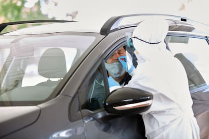 En la estación de testeos, los vehículos ingresan y los conductores y pasajeros deben bajar las ventanillas para la realización del hisopados
