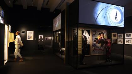 En la exposición se exhiben afiches de cine, dibujos, pinturas, vídeos, instalaciones, fragmentos de películas, vestuario, como el esmoquin de Daniel Craig en Casino Royale