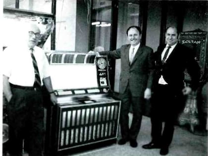 En la exposición "Simon Rock-Ola", de Nueva York, Harry Koeppel, el argentino Mauricio Mochkovsky y Larry Kauffmann examinan una máquina. Los estadounidenses que participaron de la muestra definían a Mochkovsky como "un prominente empresario de la Argentina que viajó a Nueva York en un viaje de compras estratégicas"