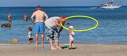 En la imagen se ve la aleta dorsal del pequeño tiburón merodeando por la playa