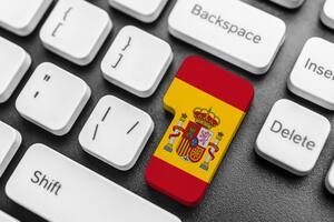 Enter key button with Flag of Spain. Close-up.