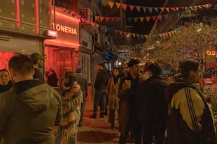 Entusiastas de la comida callejera en una acera cerca del Barrio Chino en una tarde fría de mayo en Belgrano, en Buenos Aires