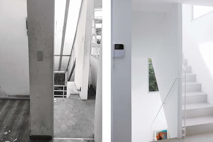 Escalera con piso de microcemento, baranda continua de caño redondo y ventanas de aluminio anodizado en color natural.