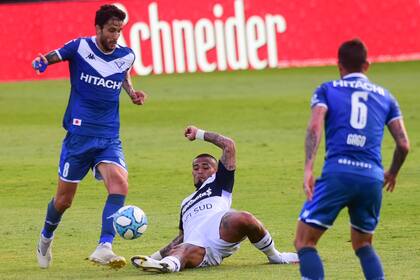 Ricky Alvarez intenta mantener la posesión del balón con Gago; Ayala busca frenar a los dos volantes de Vélez