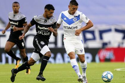 Ricardo Centurión y Matías García disputan la pelota durante el partido entre Vélez y Gimnasia, en La Plata.