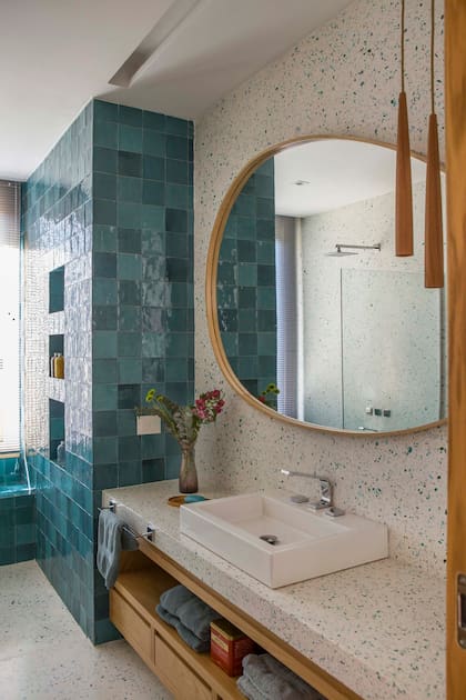 Espejo y vanitory a medida (ambos SCK Arquitectos por José Moffa) con mesada del mismo terrazo. Bacha ‘L19′ (Deca), grifería y ducha ‘Chaltén’ (FV). Mampara (Glassic).