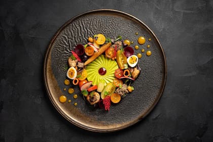 Espiral de palta con mermelada de tomates asados, huevos de codorniz, peras asadas, tomates de la huerta, vegetales encurtidos, maíz y boniato crujiente.