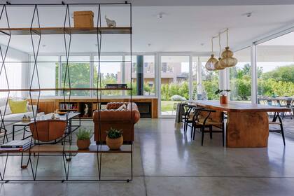 Estantería de hierro y madera (Tienda de Hierros), mesa de comedor en cedro azul (Lodd), sillas 'Wishbone' (Navarro Hábitat) y lámparas 'Farola' (La Feliz). Calefactor (Efel).