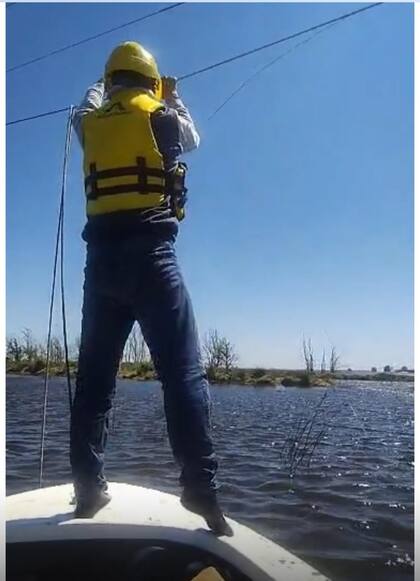 Fabricio Bonello y el equipo de la cooperativa mientras hacía tareas sobre un bote