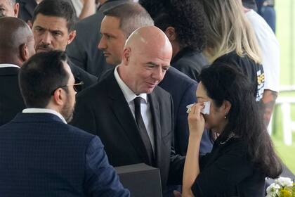 FIFA President Gianni Infantino gives his condolences to Marcia Aoki, the widow of Brazilian soccer great Pele, during the wake at Vila Belmiro stadium in Santos, Brazil, Monday, Jan. 2, 2023. (AP Photo/Andre Penner)