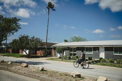 FILE Ñ A man rides a bike down Memes Street in Boca Chica Village, Texas, Feb. 25, 2024. Employees of SpaceX have filed a formal petition to create the city of Starbase. (Meridith Kohut/The New York Times)