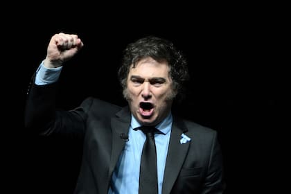 (FILES) Argentine President Javier Milei gestures during the presentation of his new book "Capitalism, Socialism, and the Neoclassical Trap" at the Luna Park stadium in Buenos Aires on May 22, 2024. Argentina's budget-slashing President Javier Milei on August 4, 2025, vetoed a law approved by parliament to increase pensions for the elderly and the disabled, arguing it undermined his attempts to balance the budget. (Photo by LUIS ROBAYO / AFP)