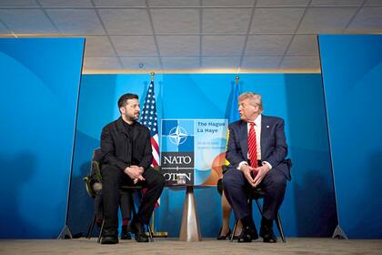 (FILES) In this handout photograph taken and released by the Ukrainian Presidential Press Service on June 25, 2025, Ukraine's President Volodymyr Zelensky (L) meets with US President Donald Trump on the sideline of the North Atlantic Treaty Organization (NATO) summit in The Hague. Ukraine appealed to the United States for clarity on July 1, 2025, after it was caught off guard by a White House announcement that Washington was halting some arms shipments to the war-battered country. The White House had said that it was halting some key weapons shipments promised by the previous US administration, without elaborating. (Photo by Handout / UKRAINIAN PRESIDENTIAL PRESS SERVICE / AFP) / RESTRICTED TO EDITORIAL USE - MANDATORY CREDIT "AFP PHOTO / Ukrainian Presidential Press Service" - NO MARKETING NO ADVERTISING CAMPAIGNS - DISTRIBUTED AS A SERVICE TO CLIENTS