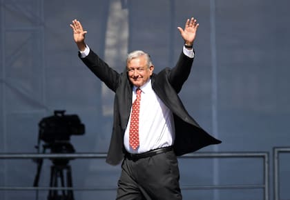 (FILES) Mexican President Andres Manuel Lopez Obrador waves during a rally marking his first year in office at the Zocalo square in Mexico City on December 1, 2019. Mexico's outgoing President Andres Manuel Lopez Obrador is a veteran leftist and self-proclaimed anti-corruption crusader who remains widely popular after near six years in office. On June 2, 2024, the country of 129 million will choose his successor. (Photo by PEDRO PARDO / AFP)�