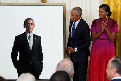 Former President Barack Obama looks at his official White House portrait with former first lady Michelle Obama during a ceremony in the East Room of the White House, Wednesday, Sept. 7, 2022, in Washington. (AP Photo/Andrew Harnik)
