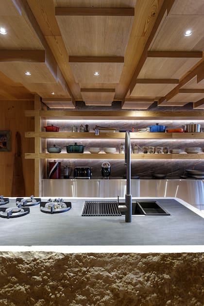 Pared revestida en Bronzite (De Stefano). Muebles de cocina forrados en acero (Concepto).