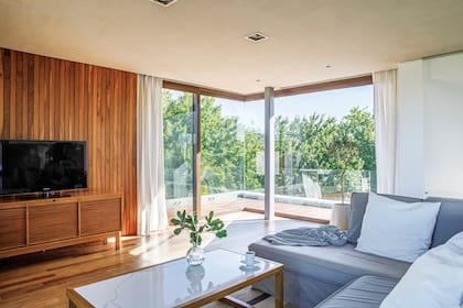 Subiendo desde la planta baja, la escalera desemboca en este estar íntimo que actúa como articulador entre los dormitorios con vistas a ambos lados del río.