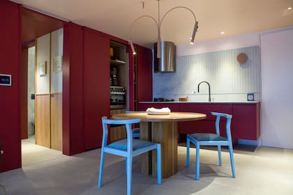 Muebles de cocina ejecutados por Dwell laqueados en el tono 'P021-2' de Colorín. Mesa 'Lysa' y sillas 'Asta' (Marini Estudio). Piso 'Adeona Antiq Duo' (San Lorenzo Design). Grifería 'Ícono Chef' (Novum).