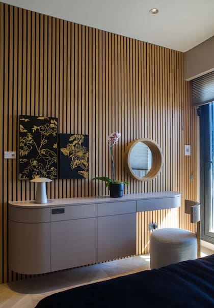 Mueble con líneas curvas en melamina “Sahara”, línea “Étnica” (Faplac), realizado por Canessa Muebles. Obra de Lucía Spotorno, “Flores de oro” (Diderot.art). Lámpara "Lula" (IDEA).