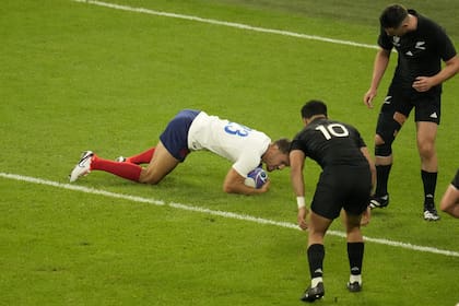 France's Melvyn Jaminet scores a try during the Rugby World Cup Pool A match between France and New Zealand at the Stade de France in Saint-Denis, north of Paris, Friday, Sept. 8, 2023. (AP Photo/Themba Hadebe)