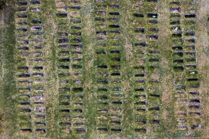 Freshly dug graves are seen at the Cementerio del Norte amid the new coronavirus pandemic in Montevideo, Uruguay, Friday, June 11, 2021. (AP Photo/Matilde Campodonico)