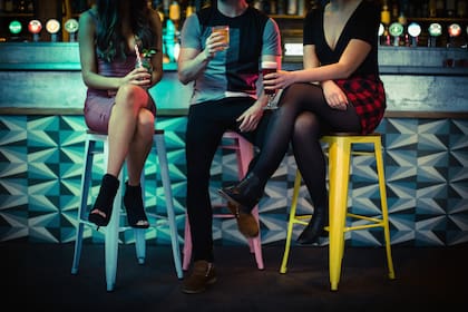 Friends enjoying the drinks at counter in bar